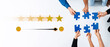 © InfiniteFlow - Diverse hands collaborate to assemble blue puzzle pieces while engaging with rating icons, depicting teamwork, satisfaction, and emotional connection in a corporate environment. Trope