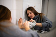 © Zoran Jesic - Woman cleaning bathroom mirror reflecting self-care
