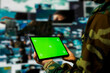 © DC Studio - Close up of air defense command operator using radar systems on green screen tablet to detect incoming ballistic missiles. Army soldier scanning rockets approaching borders using chroma key device