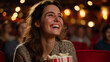 © Laura - Young woman bursting into laughter while watching a comedy film in a packed cinema, holding popcorn under dramatic warm theater lighting, defocused audience background, cinema