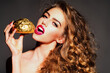 © Volodymyr - Beauty woman eat Golden Hamburger Bun. Fashion girl eat golden Bread Rolls. Gold luxury concept, beauty portrait. Luxury with gold. Glamorous beauty desire. Fashion portrait with bread.