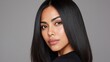 © buraratn - Elegant portrait of a young woman with long, straight hair and natural makeup against a neutral background