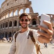 © สมชัย ้พาลแก้ว - Smiling tourist visiting Coloseum in Rome, Italy - Handsome young man taking selfie with smart mobile phone device - Traveler with backpack enjoying summer vacation - Travel and technology concept