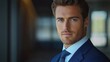 © btiger - professional portrait of a well-dressed person in a navy suit and blue tie standing in a dim modern hallway, composed and confident mood