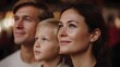© Thares2020 - A happy family of parents and a child looking sideways with warm bokeh lights in the background conveying a sense of hope and togetherness