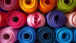© panji - A vibrant close-up of numerous colorful rolls of fabric, creating a rich texture and dynamic pattern, ideal for craft, fashion, and design projects
