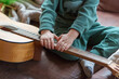 © AventuraSur - Toddler (hands in focus) trying out a guitar