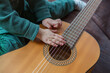 © AventuraSur - Toddler (hands in focus) trying out a guitar