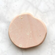 © Lauren - pebble of pink Arkose sandstone on white marble