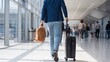 © Karuna - Traveler's Journey: A person walks purposefully through a bustling airport terminal, dragging a suitcase and carrying a bag, embodying the spirit of travel and the anticipation of new adventures.