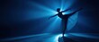 © Alba - The Ballerina Balanced on Pointe Under Dramatic Blue Stage Lighting