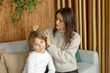 © Tomsickova - Mother, checking her sons hair for lice, precautions child hair