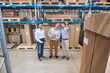 © Westend61 - Three men with tablet talking in factory warehouse