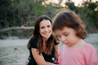 © Westend61 - Australia, Queensland, Mackay, Cape Hillsborough National Park, happy mother looking at her daughter at the beach