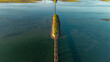 © AmazingAerialAgency - Aerial view of a narrow strip of land bisecting the tranquil lagoon, connected by a weathered bridge under a serene sky, Knysna, Western Cape, South Africa.