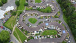© AmazingAerialAgency - Aerial view of distinctive housing estate with curved rows of houses and green spaces, a harmonious blend of urban design and nature, Newport, Wales, United Kingdom.