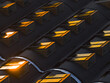 © AmazingAerialAgency - Aerial view of geometric patterns of rooftop windows reflecting golden light, creating a warm glow against the cool shadows, Roma, Lazio, Italy.