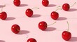 © HOSSAIN - A top-down view of vibrant red cherries scattered across a soft pink surface, casting subtle shadows, capturing a serene and inviting still life scene with fresh fruit in a minimalist environment.