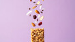 © Dina Photo Stories - Granola bar with nuts and dried fruits in motion, isolated on purple background for healthy eating and high protein snack promotion, energy and muscle building, sports supplement