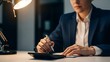 © Amiruddin - Businessman Writing on Tablet at Desk in Office