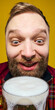 © master1305 - Bearded man holding large beer mug close up portrait against yellow background. Concept of Oktoberfest promotion, bar advertising, beverage branding, and seasonal marketing visuals.