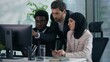 © Yuliia - Multicultural business colleagues teamwork in office multiracial three co-workers working together diversity partners businesspeople talking pointing in computer meeting brainstorming work process