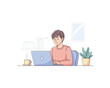 © malsha - Casual young man focuses intently while working remotely on a laptop computer from home