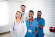 © Jelena - Diverse medical team standing together smiling at hospital