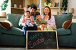 © djile - Family sitting on sofa with happy easter sign