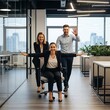 © Angel - Business Colleagues Playing Office Chair in Modern Office Space