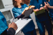 © Daniel Gonzalez/Stocksy - Veterinary staff collaborating on patient records clipboard