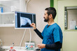 © Daniel Gonzalez/Stocksy - Veterinarian analyzing patient X-ray in clinic