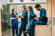 © Daniel Gonzalez/Stocksy - Veterinary staff collaborating and discussing patient care in clinic