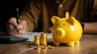 © azrina - Piggy bank with gold coins reflects financial planning and savings concepts