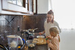 © Evgenij Yulkin/Stocksy - Woman and little daughter cooking in the kitchen