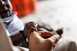 © Alvaro Lavin/Stocksy - Baby hand holding adult finger showing connection