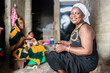 © Alvaro Lavin/Stocksy - African woman smiling preparing food with family in Senegal