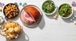 © Running opossum - easter feast with glazed ham, roasted potatoes, and fresh salad on a white table