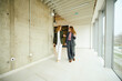 © Boris Jovanovic/Stocksy - Elegant women walk through corporate building
