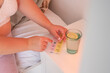 © Milles Team/Stocksy - Woman taking medicine from pill box