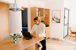 © Adrian Rodd/Stocksy - Modern man working remotely in his living room