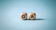© Naz Piczz - Two Wooden Blocks with Q and A Letters on a Light Blue Q and A, question, answer, wooden blocks