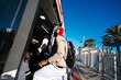 © Ezequiel Giménez/Stocksy - Man boarding modern train from urban platform