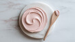 © Sevinj - An artistic swirl of thick, creamy pink clay mask on a smooth white marble slab