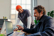 © BONNINSTUDIO/Stocksy - Business colleagues collaborating on laptop in modern office