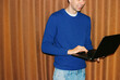 © Artem Podrez/Stocksy - Business Professional in Blue Sweater Using Laptop