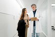 © Santi Nuñez/Stocksy - Doctor discussing medical information with patient in hospital