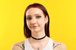 © New Africa - Portrait of beautiful young woman with different face piercings on yellow background