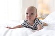 © New Africa - Cute little baby on bed at home