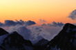 © Nicat - Dramatic sunset light illuminates clouds above majestic snow-capped mountains. Serene atmosphere enhances the beauty of the mountainous region outdoors